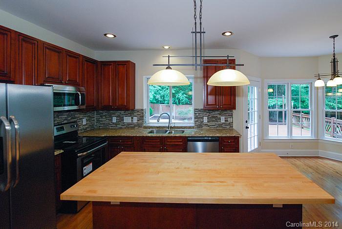 7131 Forest Ridge Road Weddington, NC 28104 - Photo 10 of 23 a kitchen with stainless steel appliances granite countertop a sink a stove and a refrigerator