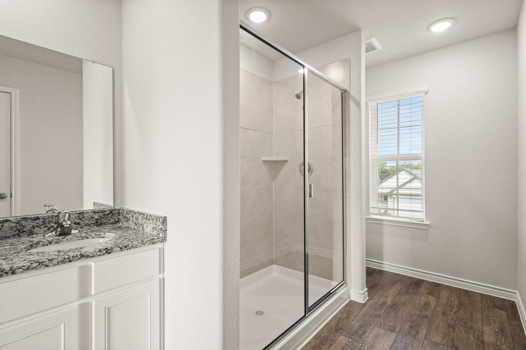 1511 Romans Road Ennis, TX 75119 - Photo 12 of 22 a bathroom with a granite countertop sink mirror and shower