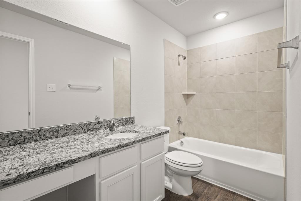 1511 Romans Road Ennis, TX 75119 - Photo 15 of 22 a bathroom with a granite countertop sink toilet and shower