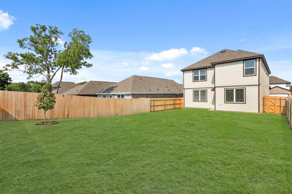 1511 Romans Road Ennis, TX 75119 - Photo 20 of 22 a view of a house with a yard and a large tree