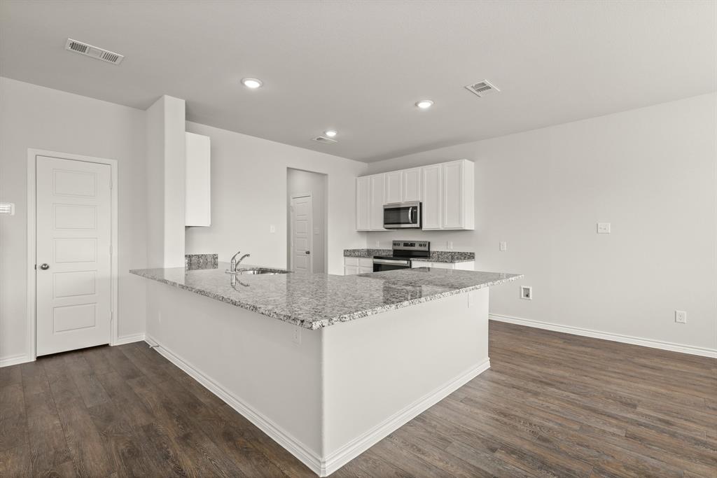1511 Romans Road Ennis, TX 75119 - Photo 5 of 22 a kitchen with stainless steel appliances granite countertop a sink and cabinets