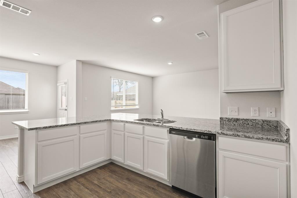 1511 Romans Road Ennis, TX 75119 - Photo 6 of 22 a kitchen with a sink stove and cabinets