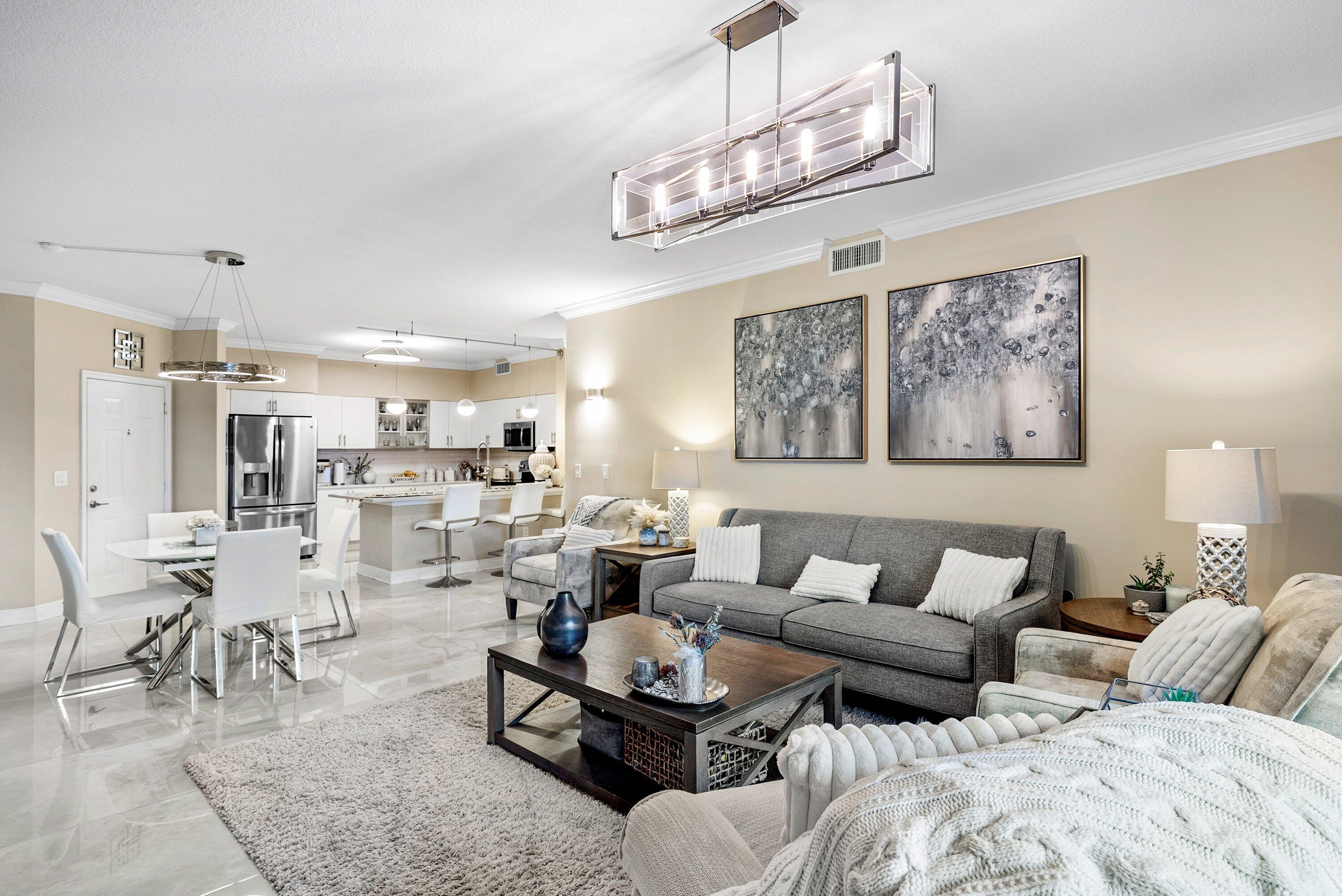 233 South Federal Highway, Unit 509 Boca Raton, FL 33432 - Photo 9 of 49 a living room with furniture kitchen view and a chandelier