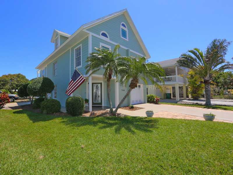 746 Jacaranda Road Anna Maria, FL 34216 - Photo 1 of 1 a view of a house with a yard and a patio