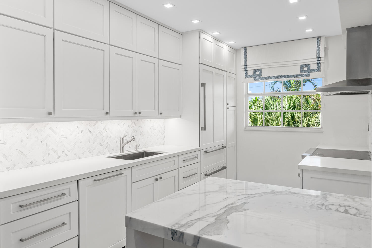 127 Peruvian Avenue, Unit 302 Palm Beach, FL 33480 - Photo 16 of 52 a kitchen with a sink window and cabinets