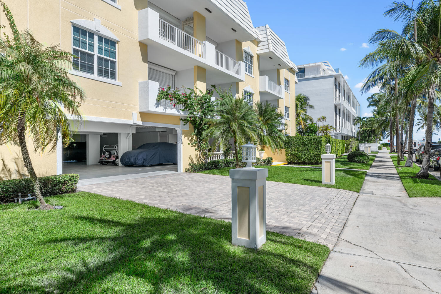 127 Peruvian Avenue, Unit 302 Palm Beach, FL 33480 - Photo 2 of 52 a front view of a building with a yard and trees