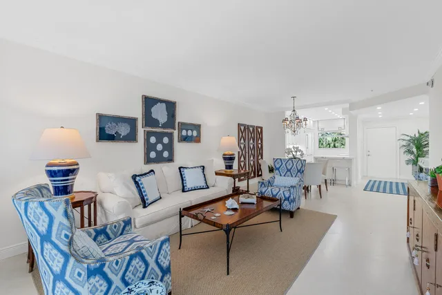 a view of a livingroom with furniture a rug and a potted plant