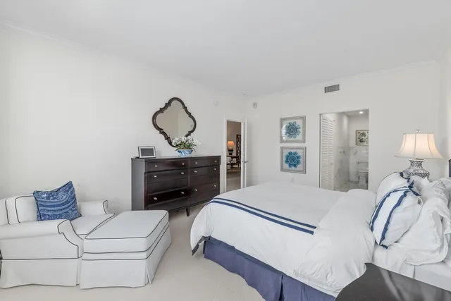 a bathroom with a double vanity sink toilet mirror and shower