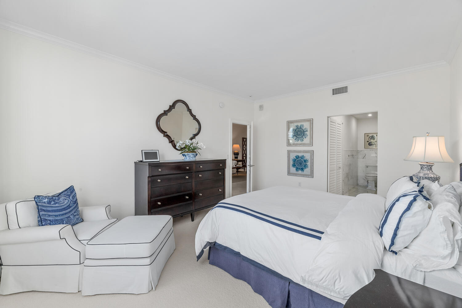 127 Peruvian Avenue, Unit 302 Palm Beach, FL 33480 - Photo 43 of 52 a bedroom with a bed and a chandelier