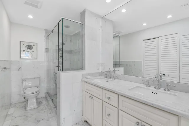 a spacious bathroom with a double vanity sink a mirror and a bathtub