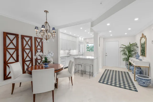 a room with furniture a chandelier and a rug