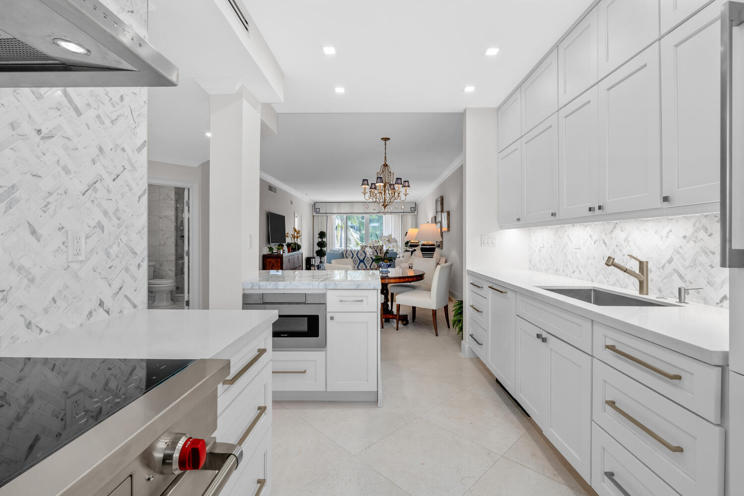 127 Peruvian Avenue, Unit 302 Palm Beach, FL 33480 - Photo 8 of 52 a kitchen with white cabinets and sink