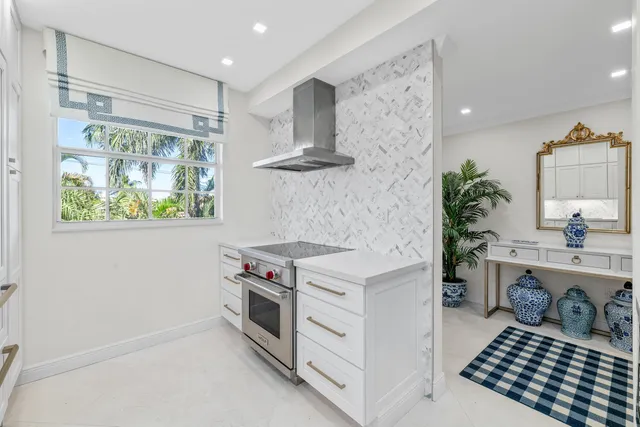 a kitchen with granite countertop white cabinets and a sink