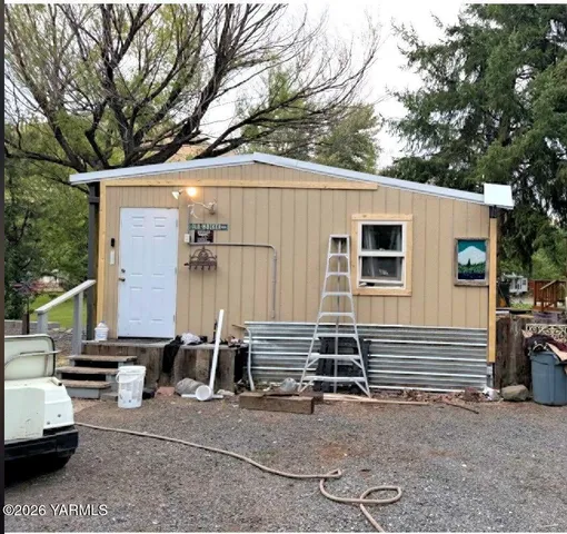 a view of house with backyard space and seating area