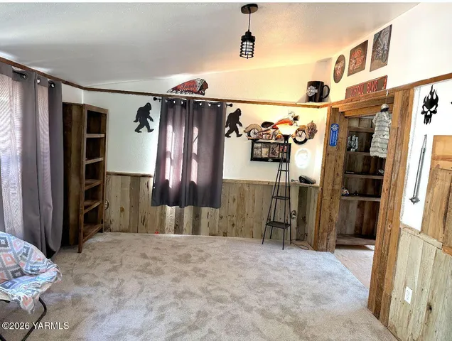 a view of a livingroom with furniture and closet