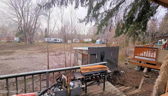 a backyard of a house with table and chairs
