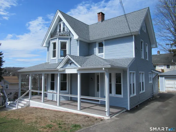 a view of entryway with wooden floor and a front door
