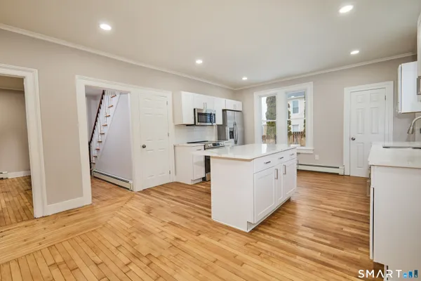 a kitchen with stainless steel appliances granite countertop a stove and a refrigerator