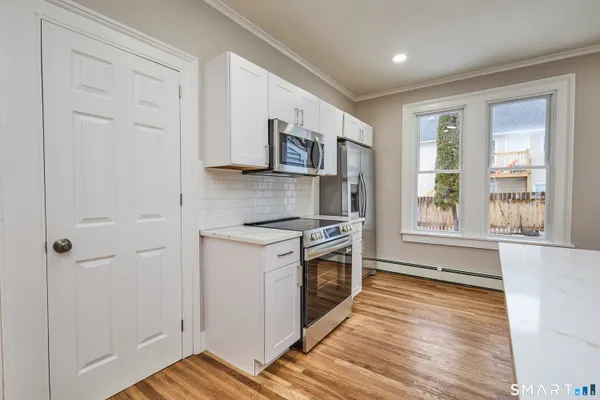 a kitchen with stainless steel appliances a stove a sink and a refrigerator