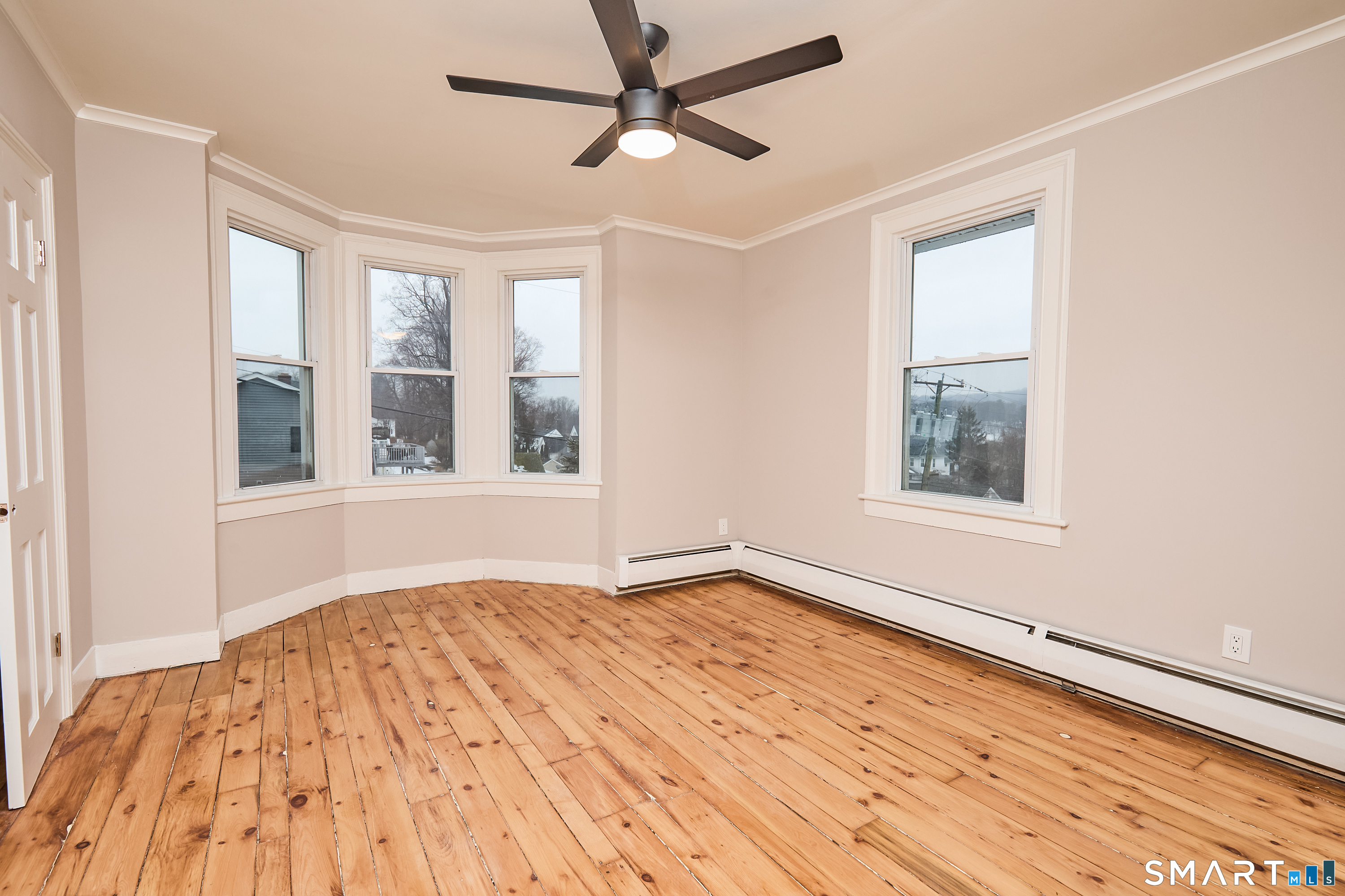 17 Grand Street Seymour, CT 06483 - Photo 19 of 40 a view of an empty room with a window and wooden floor