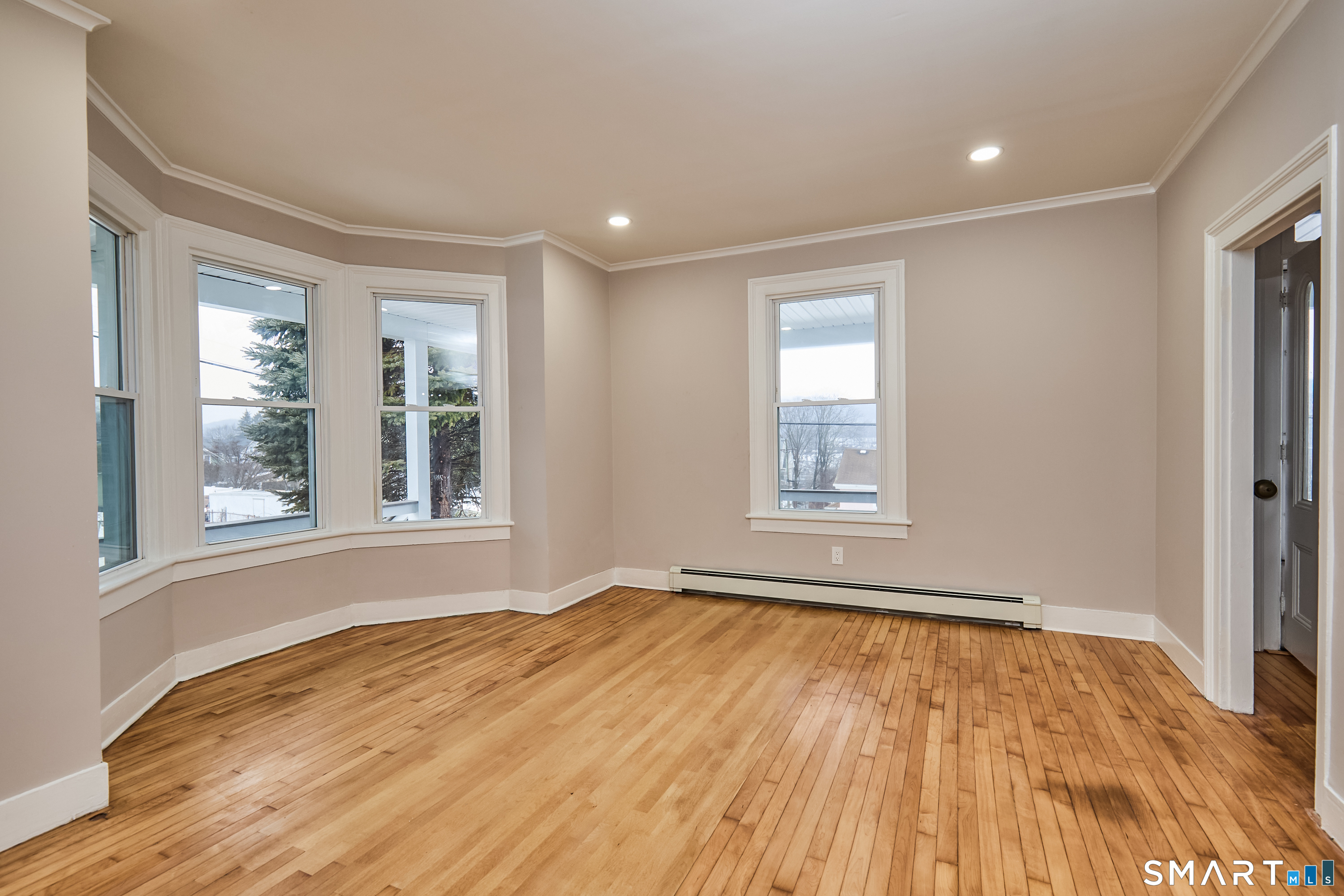 17 Grand Street Seymour, CT 06483 - Photo 20 of 40 a view of an empty room with wooden floor and a window