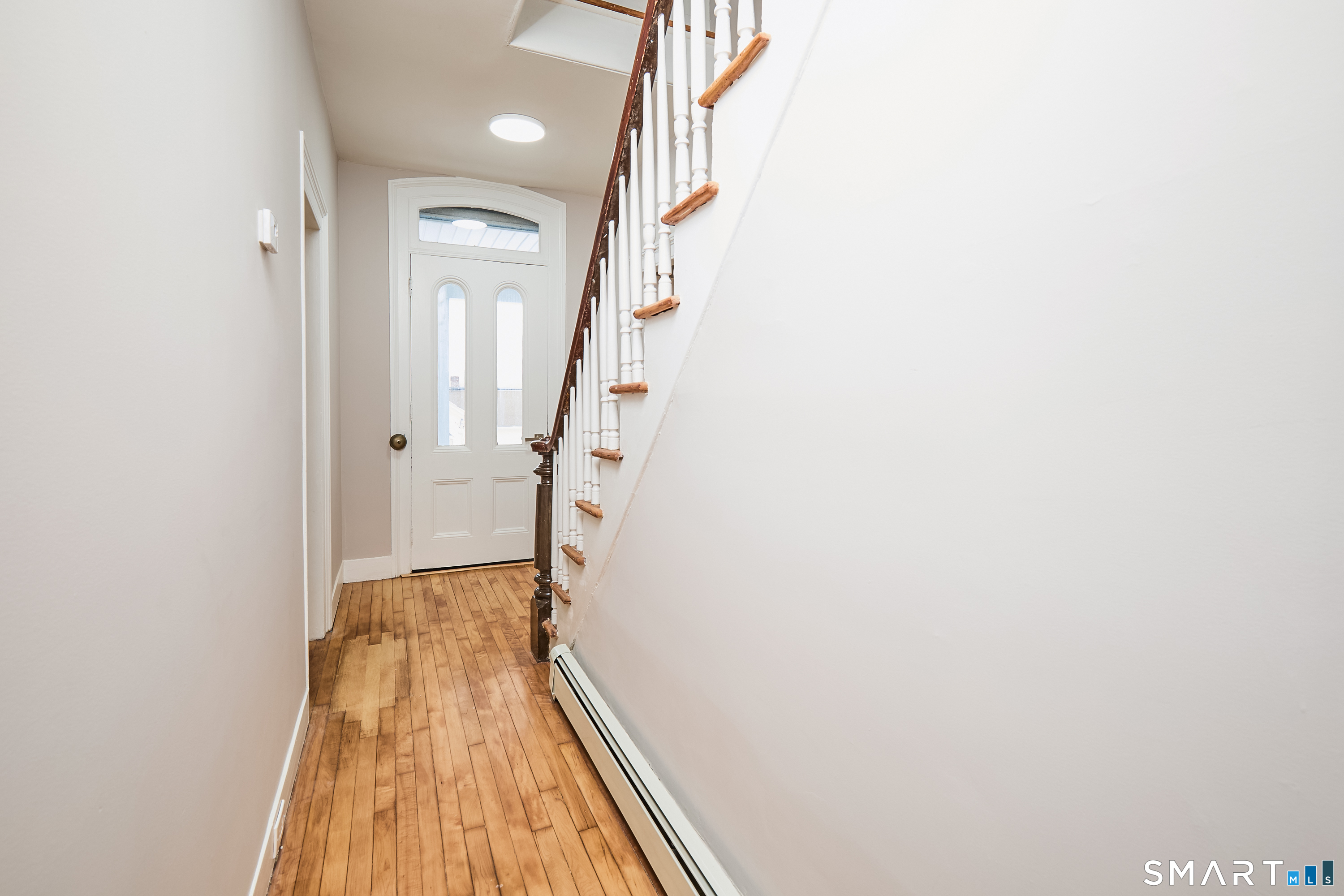17 Grand Street Seymour, CT 06483 - Photo 22 of 40 a view of a hallway with wooden floor and staircase
