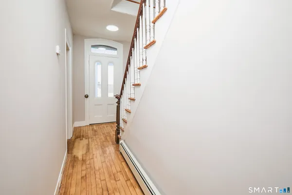 a view of a room with wooden floor and a sink