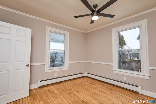 wooden floor in an empty room with a window