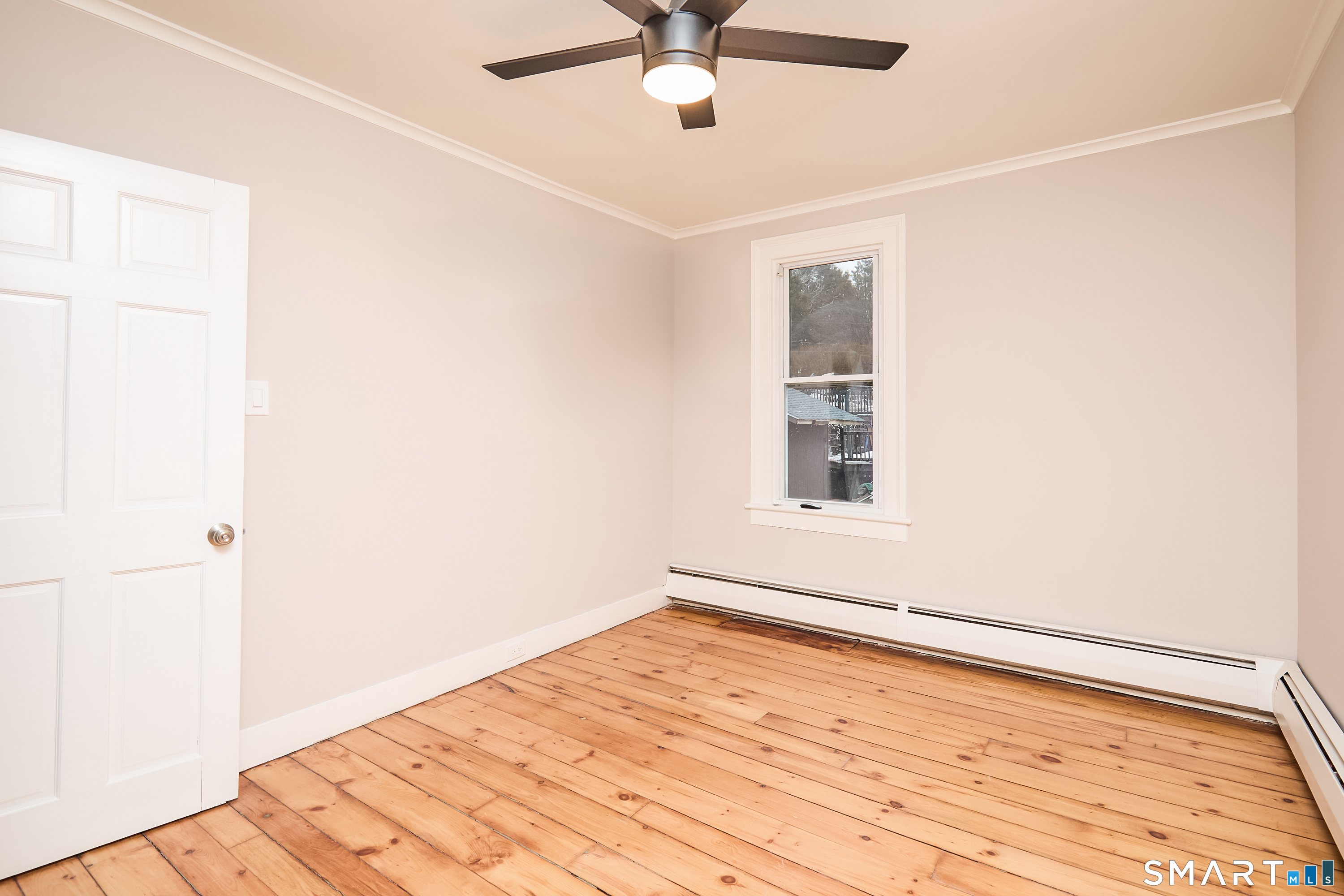 17 Grand Street Seymour, CT 06483 - Photo 31 of 40 a view of an empty room with wooden floor and a window