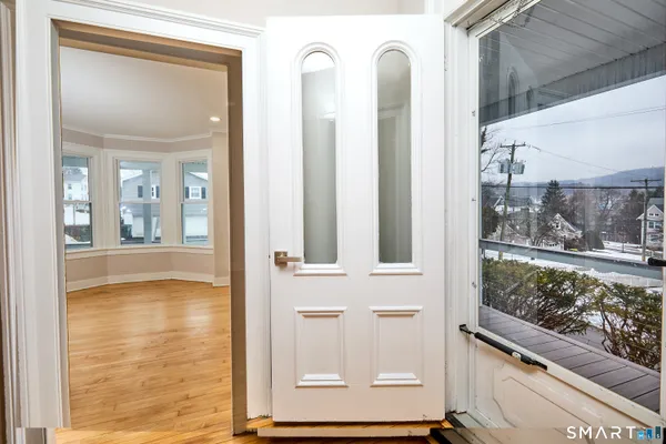 a view of an entryway with wooden floor and stairs