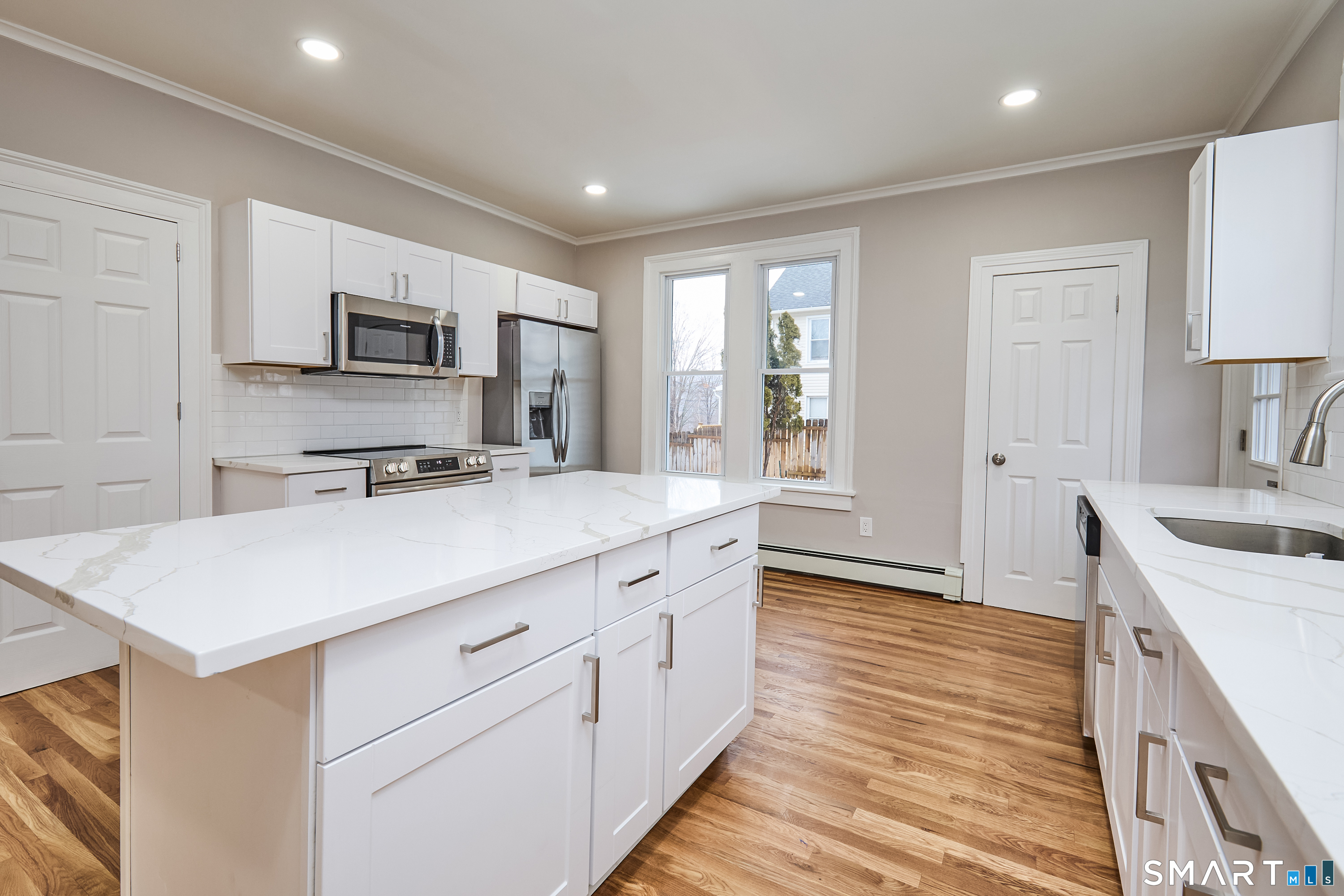 17 Grand Street Seymour, CT 06483 - Photo 7 of 40 a kitchen with kitchen island white cabinets and refrigerator