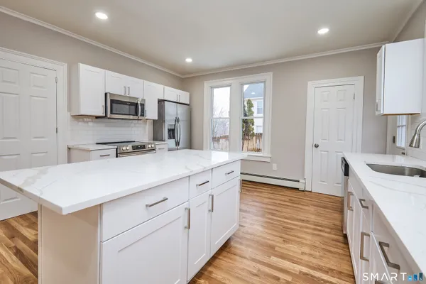 a kitchen with granite countertop a sink and cabinets