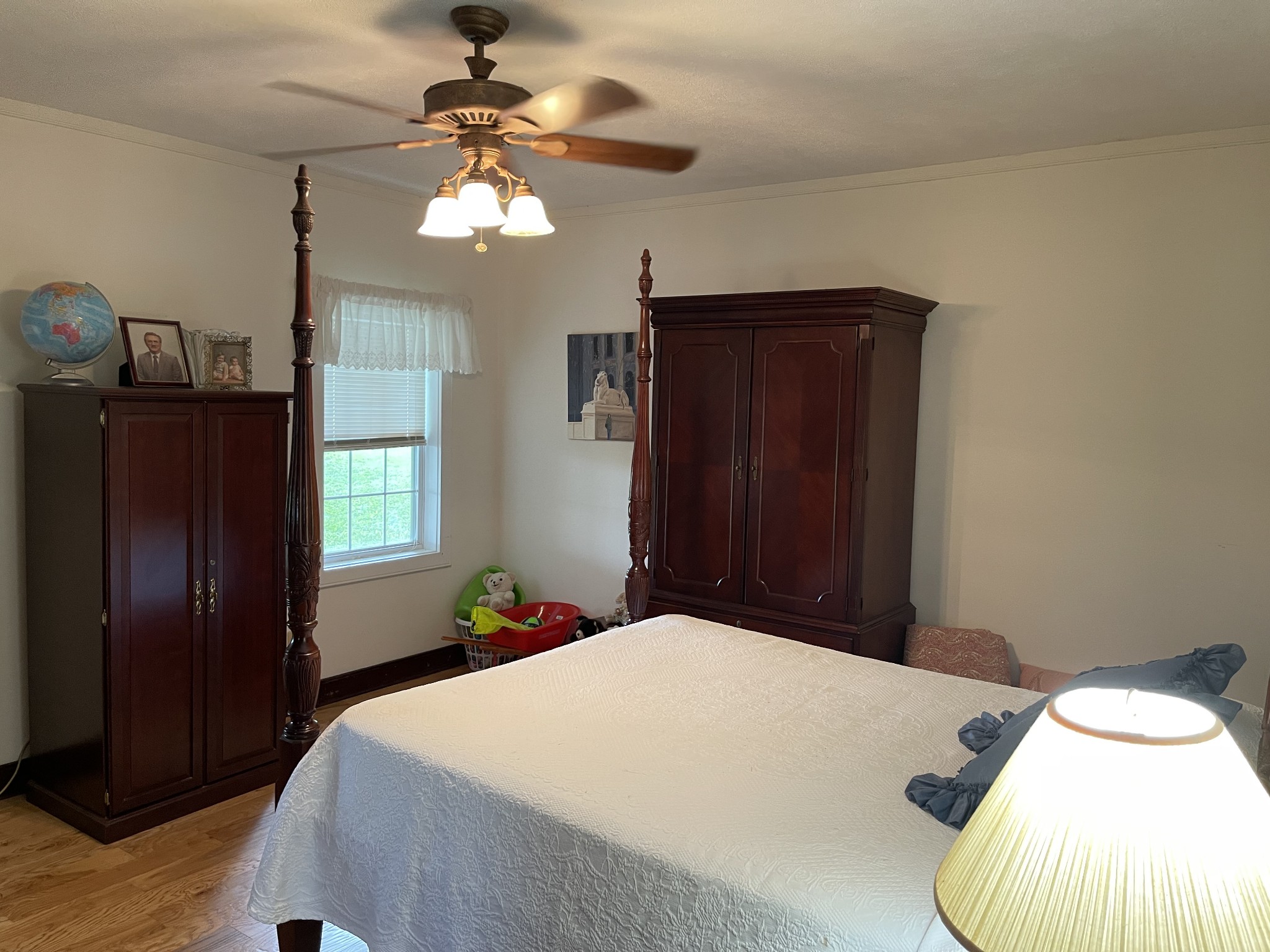 2058 Bodenham Road Pulaski, TN 38478 - Photo 22 of 38 a bedroom with a bed and a chandelier