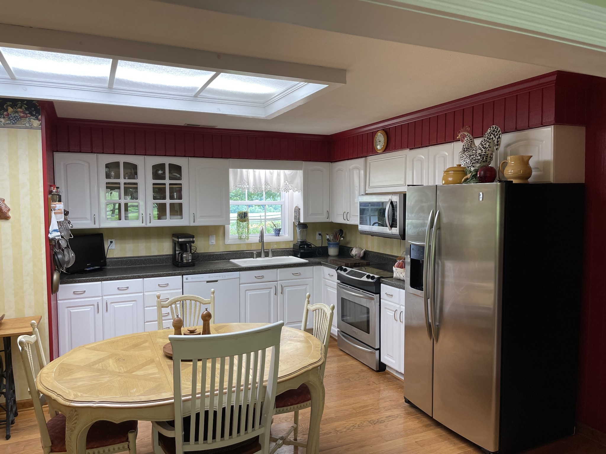 2058 Bodenham Road Pulaski, TN 38478 - Photo 8 of 38 a kitchen with stainless steel appliances granite countertop a stove a refrigerator a sink a dining table and chairs