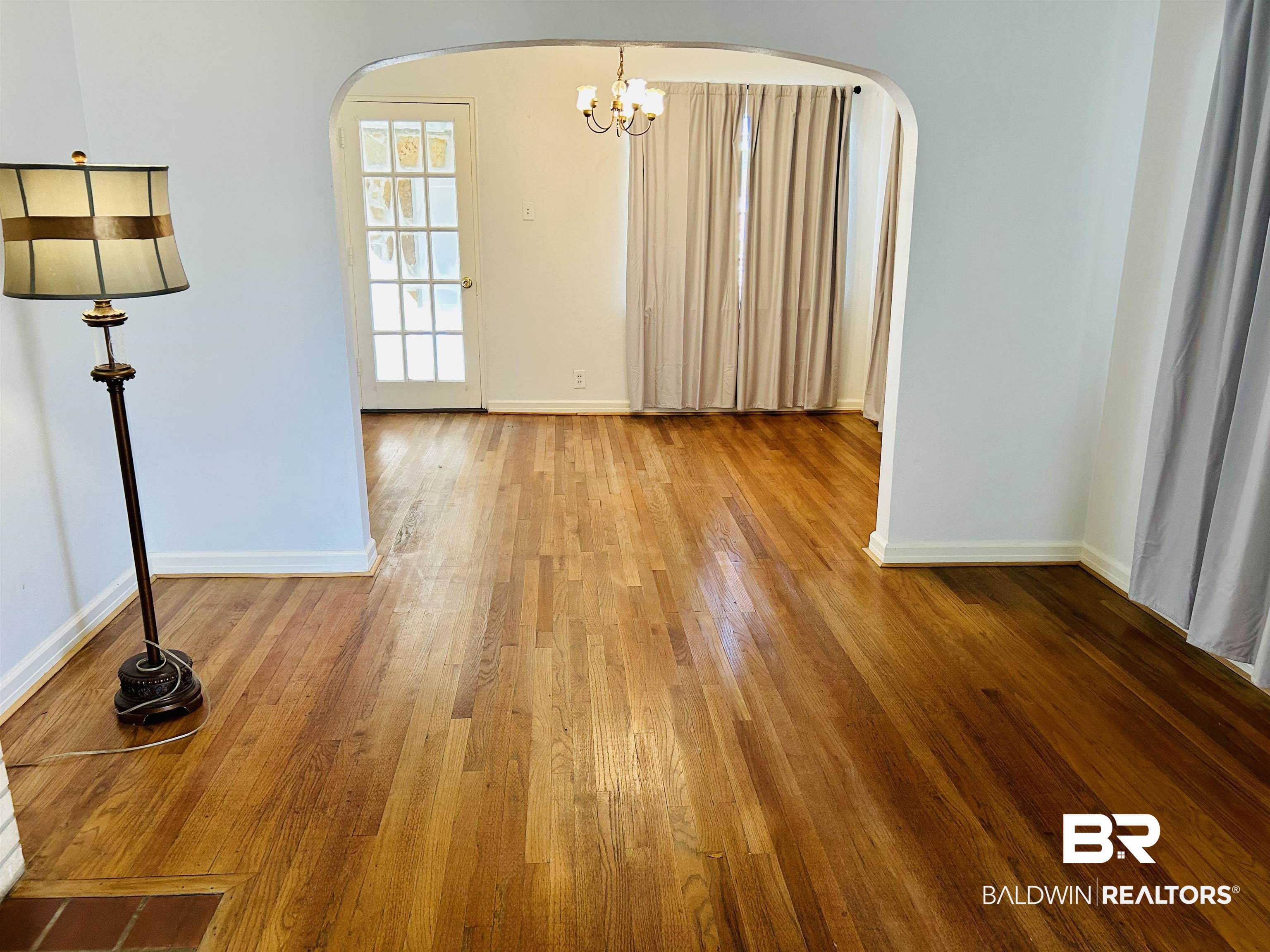 94 Diamond Street Mobile, AL 36611 - Photo 10 of 30 Spare room with hardwood / wood-style flooring and a chandelier