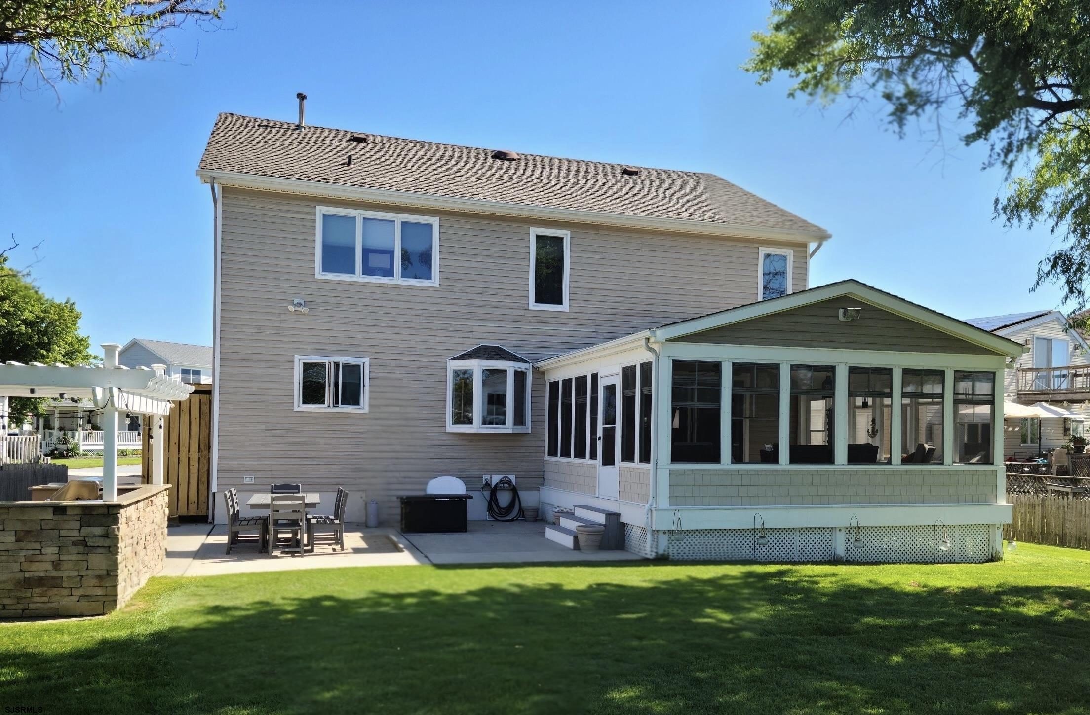 16 Collette Circle Brigantine, NJ 08203 - Photo 3 of 13 a front view of a house with a yard and porch