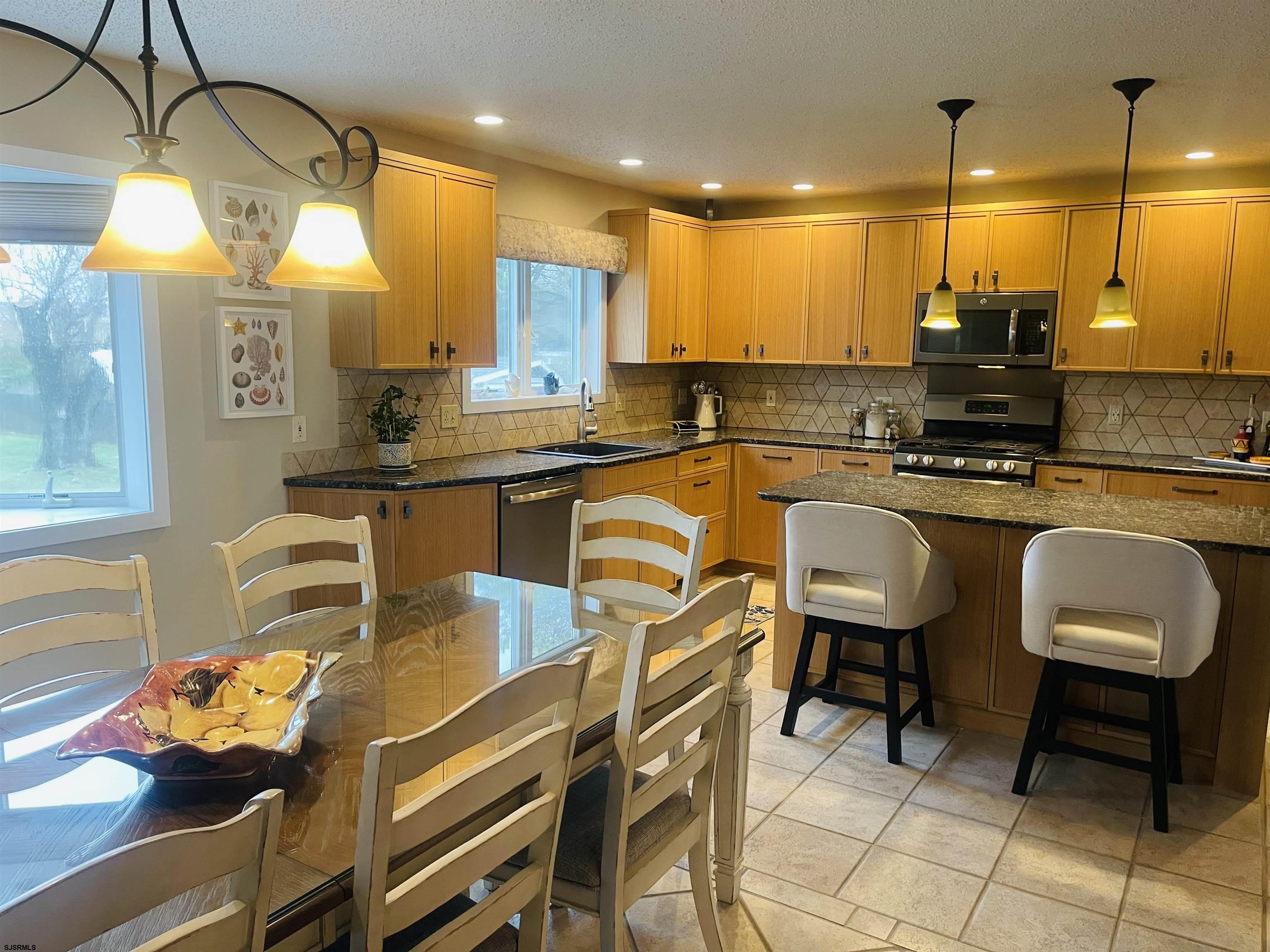 16 Collette Circle Brigantine, NJ 08203 - Photo 5 of 13 a kitchen with a table chairs stove and cabinets