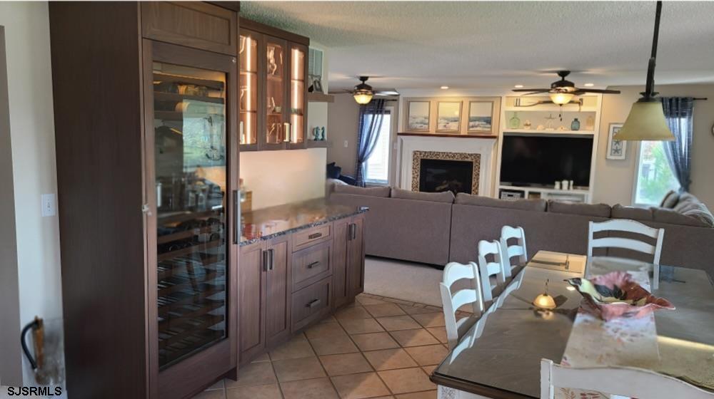 16 Collette Circle Brigantine, NJ 08203 - Photo 6 of 13 a living room with furniture a flat screen tv and kitchen view