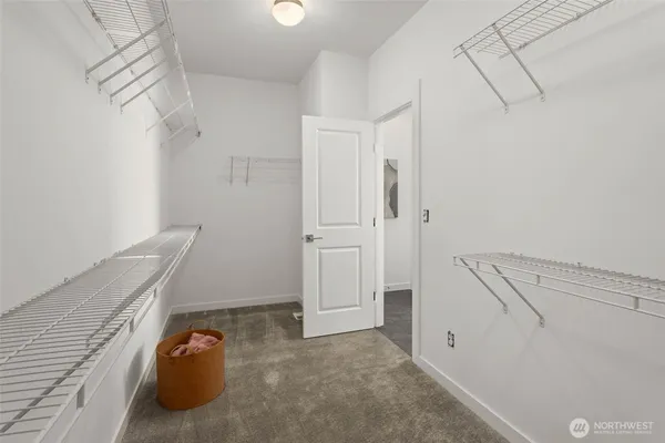 a view of walk in closet with empty racks