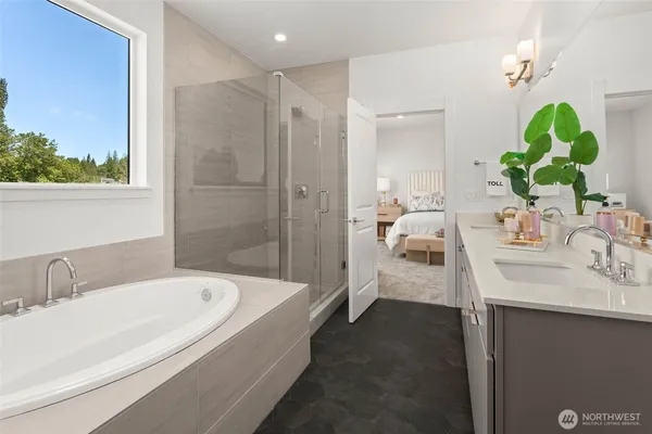 a en suite bathroom with a granite countertop tub