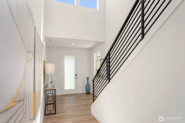 a view of a hallway with wooden floor and staircase