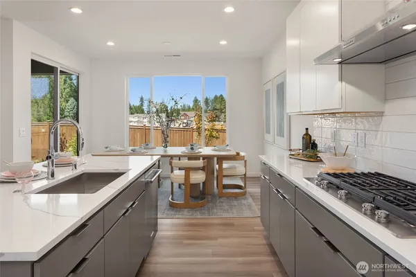 a kitchen with kitchen island a sink stove and cabinets