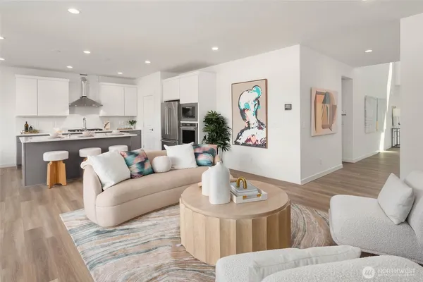 a living room with furniture kitchen and a table