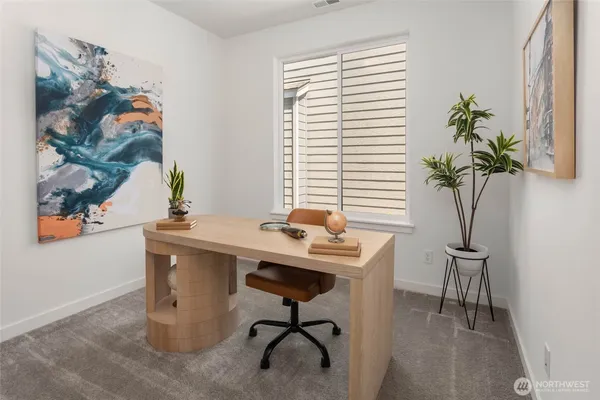 a view of a workspace with a window and sitting area