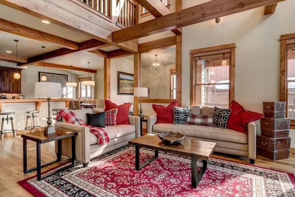 a living room with furniture a rug and a large window