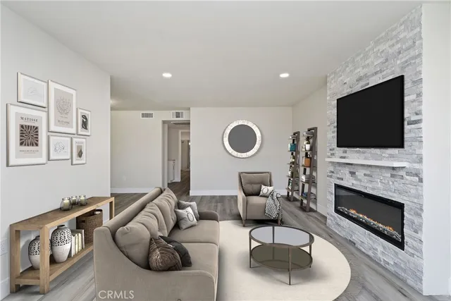 a living room with furniture a fireplace and a flat screen tv