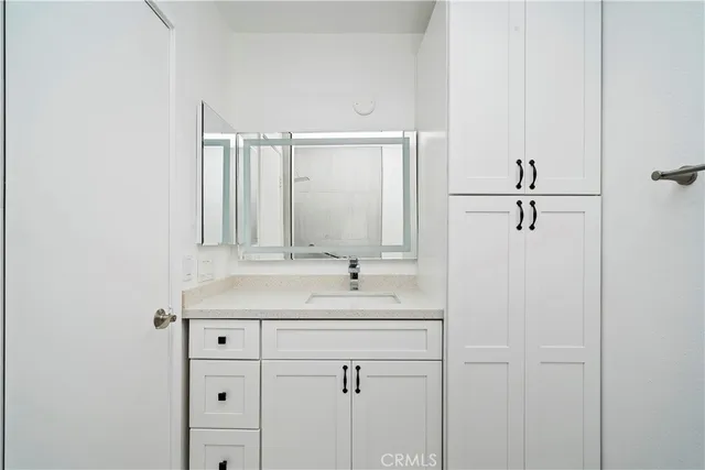 a bathroom with a sink and mirror