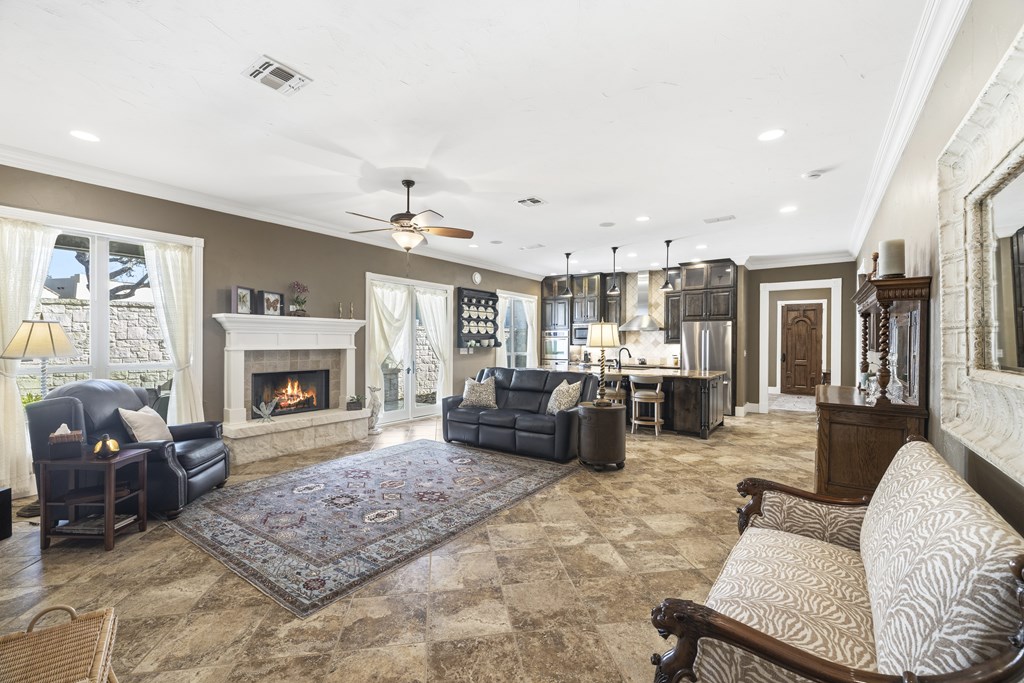 150 St Andrews Loop Kerrville, TX 78028 - Photo 5 of 27 a living room with furniture large window and a fireplace
