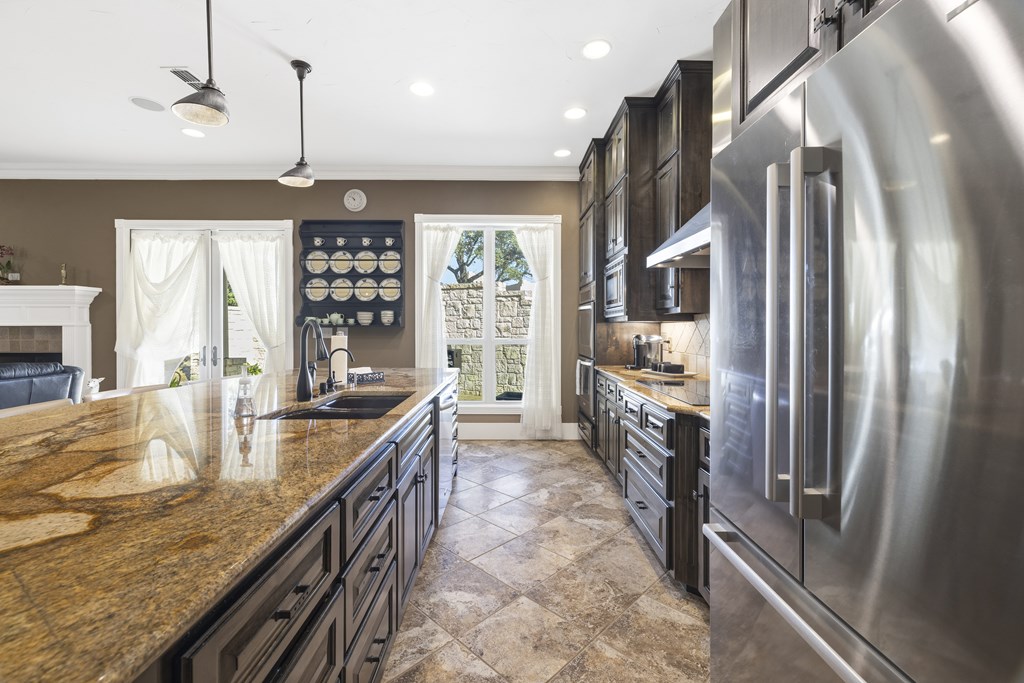 150 St Andrews Loop Kerrville, TX 78028 - Photo 6 of 27 a kitchen with counter top space and stainless steel appliances