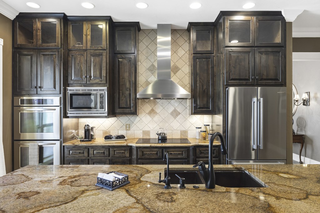 150 St Andrews Loop Kerrville, TX 78028 - Photo 8 of 27 a kitchen with stainless steel appliances granite countertop a refrigerator and a stove